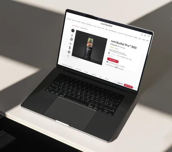 nutribullet Pro 900 website on a black laptop on a white table.