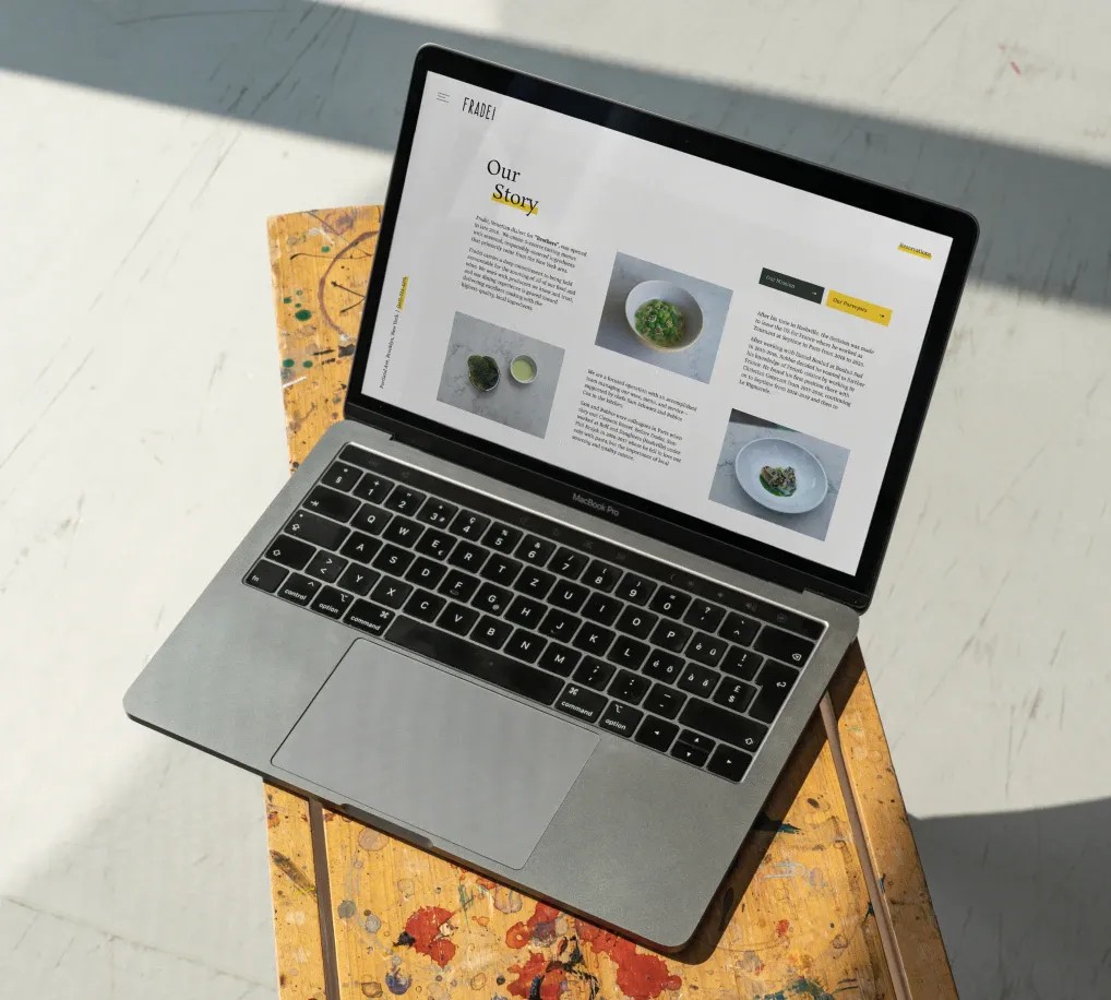 Image of a laptop on a yellow and white background.